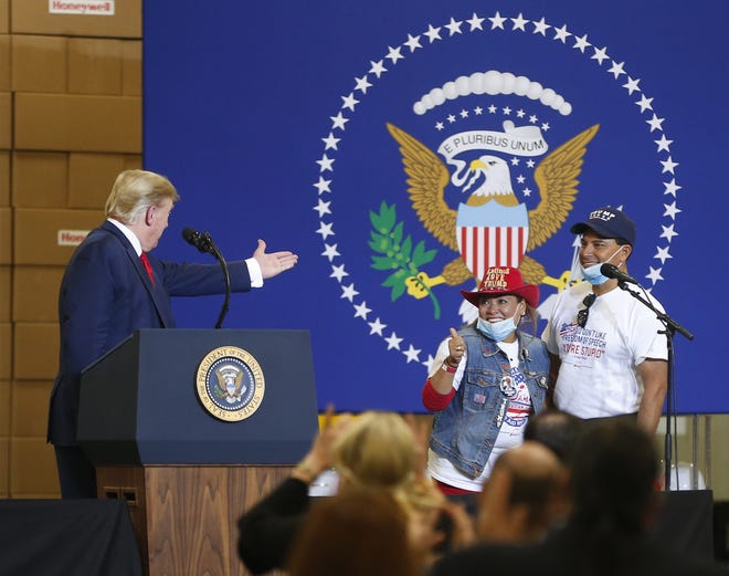 President Donald Trump acknowledges Sammy's Mexican Grill owners Betty and Jorge Rivas while speaking at Honeywell International's mask-making operation in Phoenix on May 5, 2020.