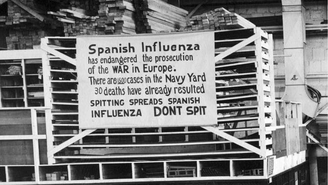 FILE - In this Oct. 19, 1918 file photo provide by the U.S. Naval History and Heritage Command a sign is posted at the Naval Aircraft Factory in Philadelphia that indicates, the Spanish Influenza was then extremely active. Science has ticked off some major accomplishments over the last century. The world learned about viruses, cured various diseases, made effective vaccines, developed instant communications and created elaborate public-health networks. Yet in many ways, 2020 is looking like 1918, the year the great influenza pandemic raged. (U.S. Naval History and Heritage Command via AP)