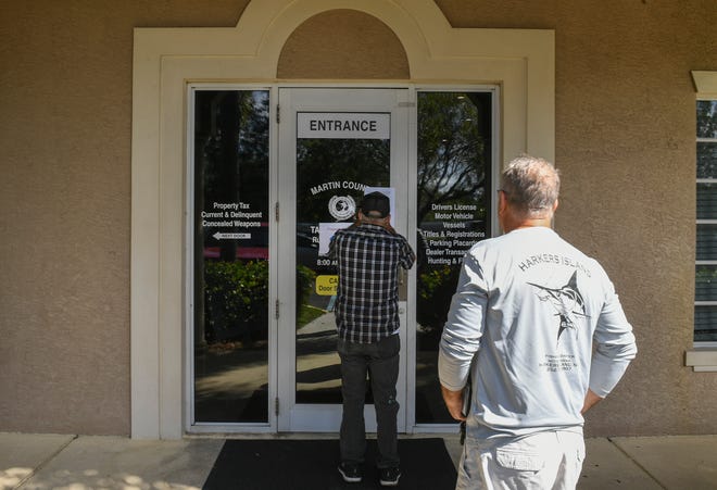 Customers of the Martin County Tax Collector's Office walk up to a locked door, posted with a letter about network issues, at the main office in Willoughby Commons. Customers were unable to do motor-vehicle-related transactions on Monday, Nov. 1, 2021, in Stuart.