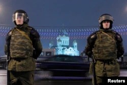 FILE - Interior Ministry officers stand guard during a rally in Bolotnaya Square, in Moscow, Dec. 10, 2011.