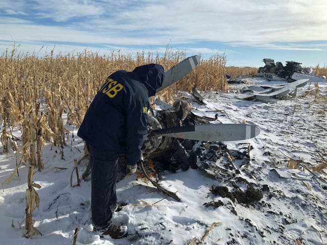 An NTSB air safety investigator examines the wreckage of the Pilatus PC-12 that crashed on Nov. 30, 2019,  shortly after departure from Chamberlain Municipal Airport. Nine people died.